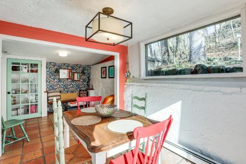 a dining room with a wooden table and red chairs at Lambertville Retreat - Walk to Shopping and Dining! in Lambertville