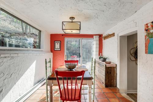 a dining room with a table and two red chairs at Lambertville Retreat - Walk to Shopping and Dining! in Lambertville