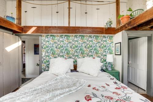 a bedroom with a large bed with a floral wallpaper at Lambertville Retreat - Walk to Shopping and Dining! in Lambertville