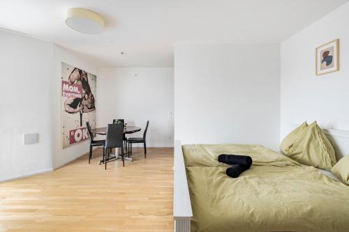 a bedroom with a bed and a dining room with a table at Central Station Loft - Amazing View in City Center - jupihome in Vienna