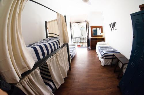 two bunk beds in a room with wooden floors at BA Stop Hotel House in Buenos Aires