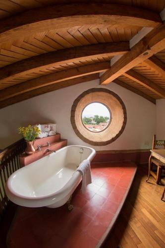 a bath tub in a room with a window at Hotel Boutique Posada La Basilica in Pátzcuaro