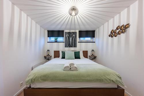 a bedroom with a bed with two slippers on it at Watervillashiraz in Aalsmeer