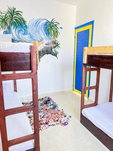 a room with two bunk beds and a pile of trash at Boilers Surf House in Tamri