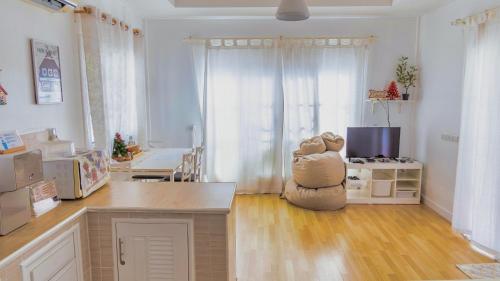 a living room with a kitchen with a table and a room with at Baan Casita With Private Seaside Cottage in Hua Hin