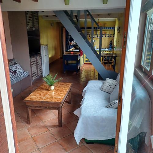 a living room with a couch and a table at LA PETITE GRANGE in Fresnes-Tilloloy