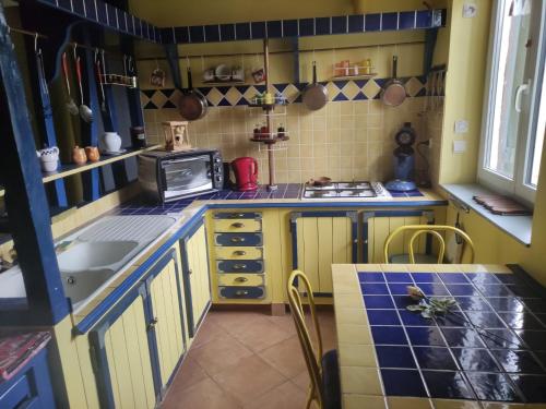 a small kitchen with a sink and a stove at LA PETITE GRANGE 
