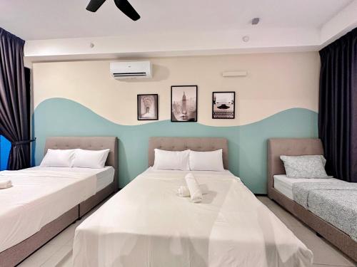 two beds in a room with two bedsitures at Urban Suite Cozy Family Homestay at Georgetown by URBAN STAYCATION HENG LOD in Jelutong