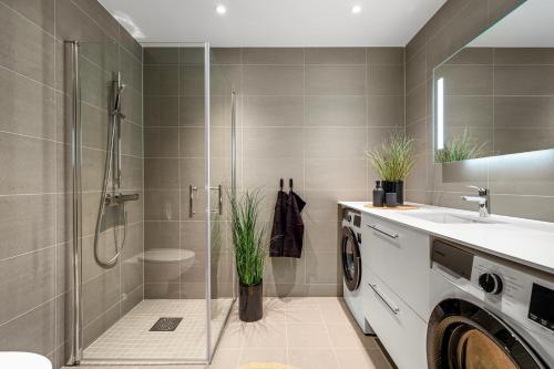 ein Badezimmer mit Dusche und Waschbecken in der Unterkunft Toppleilighet på bryggen i Sogndal med fantastisk utsikt in Sogndal