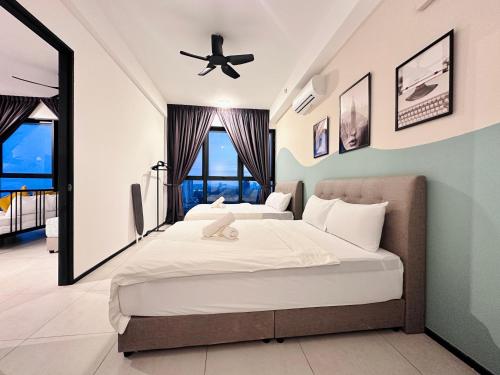 a bedroom with two beds and a ceiling fan at Urban Suite Cozy Family Homestay at Georgetown by URBAN STAYCATION HENG LOD in Jelutong