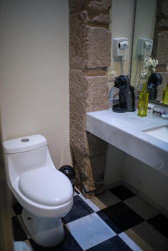 a bathroom with a toilet and a sink at Hotel Gertrudis in Morelia