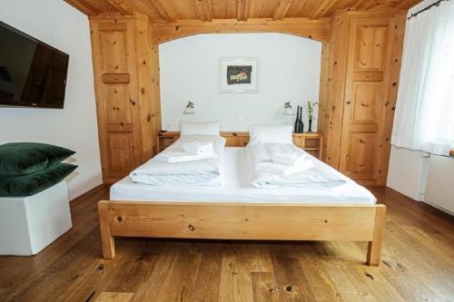 a bedroom with a bed in a wooden room at Unterkunft CASA LA RODA NR 5 URSIN in Sedrun