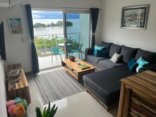 a living room with a couch and a table at Punta Esmeralda by Punta Leona in Puntarenas