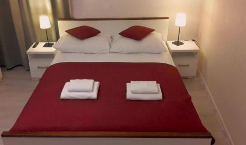 a bedroom with a bed with two white towels on it at CENTRAL WAWEL Apartments in Krakow