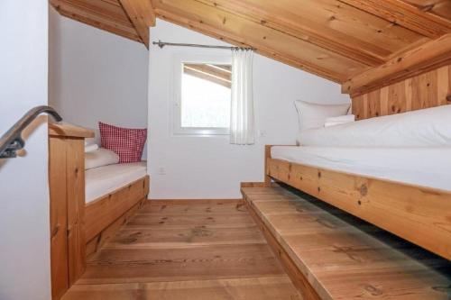 a bedroom with two beds and a window at Casa La Roda Nr 3 in Sedrun