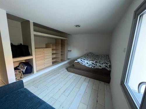 a bedroom with a bed and a large window at Magnifique maison contemporaine proche lac d’Aix in Aix-les-Bains