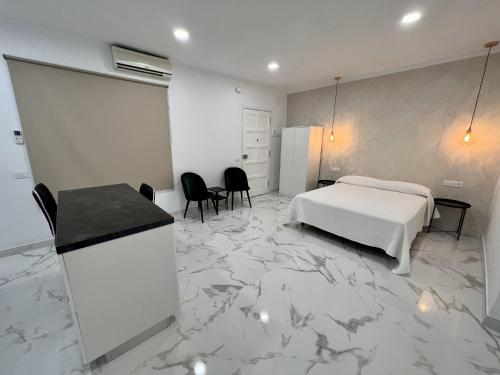 a hotel room with a bed and a table and chairs at Edificio Rambla Pulido in Santa Cruz de Tenerife