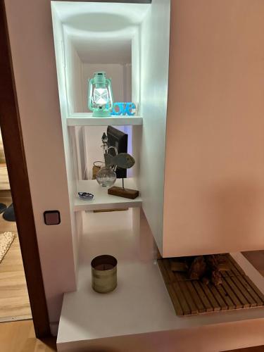 a room with a shelf with a clock on it at Solo Atico Guest Suites in L'Escala