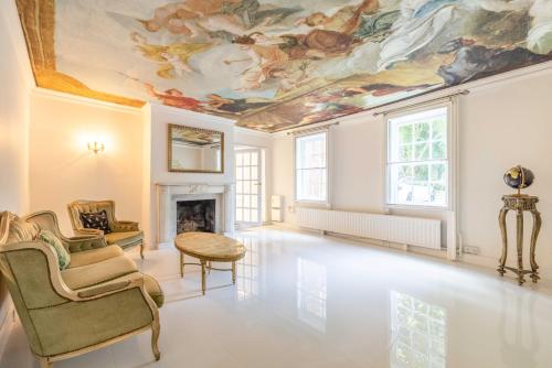 a living room with a ceiling with paintings at Royal Windsor Country Estate Private 5 Acres of Gardens in Windsor