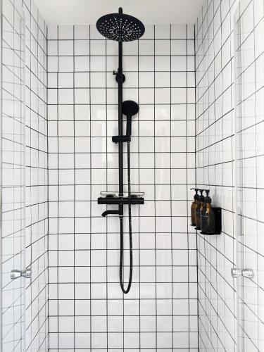 a shower with an umbrella hanging on a wall at Apartment in former Bathhouse in Amsterdam