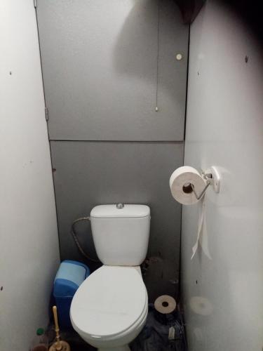 a small bathroom with a toilet and a roll of toilet paper at Pohodlná bytovka in Prešov