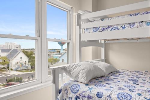 a bedroom with a bunk bed and a window at Oceanfront Villa 1 - Boardwalk Oceanfront in Ocean City