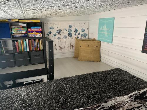 a room with a book shelf and a rug at Lively Pet-Welcoming Tiny Haven in Bustling Clermont! in Clermont