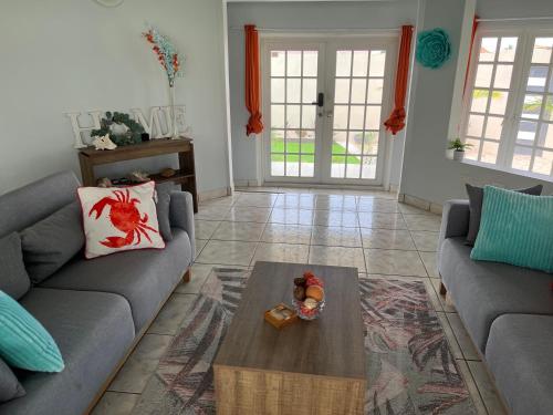 a living room with a couch and a coffee table at La Villas at Pos Chiquito Caribbean Paradise in Aruba in Savaneta