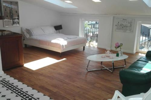 a bedroom with a bed and a table and a couch at Z widokiem- Old Town in Kraków