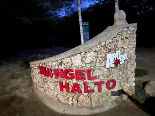 a stone wall with a sign that reads angel hallo at La Villas at Pos Chiquito Caribbean Paradise in Aruba in Savaneta
