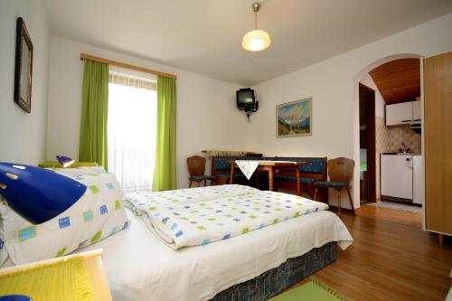 sypialnia z łóżkiem i jadalnią w obiekcie Gästehaus Lienharterhof w mieście Obertilliach