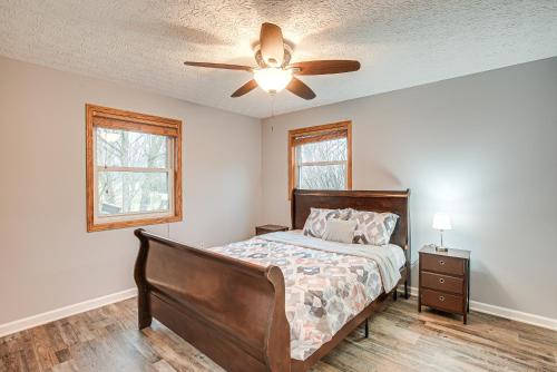 a bedroom with a bed and a ceiling fan at Spacious Delaware Home with Private Hot Tub! in Delaware