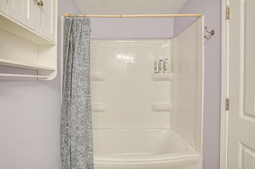 a white shower with a shower curtain in a bathroom at Spacious Delaware Home with Private Hot Tub! in Delaware