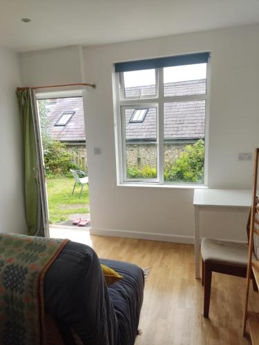 a living room with a window and a couch at Garden Room in Cardigan