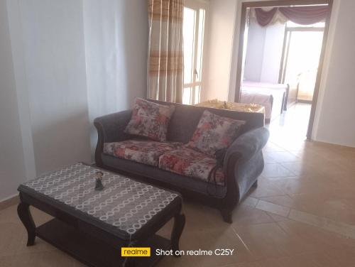 a living room with a couch and a coffee table at الفيروز in Hurghada