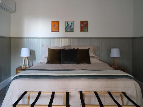 a bedroom with a large bed with two lamps at Shawwood Estate in Mudgee