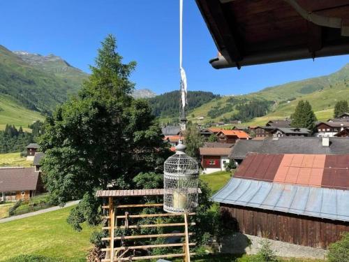 a bird cage sits on top of a village at Gemütliche 45 Zimmerwohnung in den Bündner Bergen bei Sedrun in Rueras