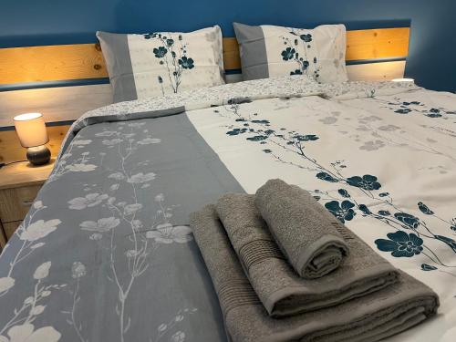a bed with two towels on top of it at Стаи за гости малчика in Plovdiv