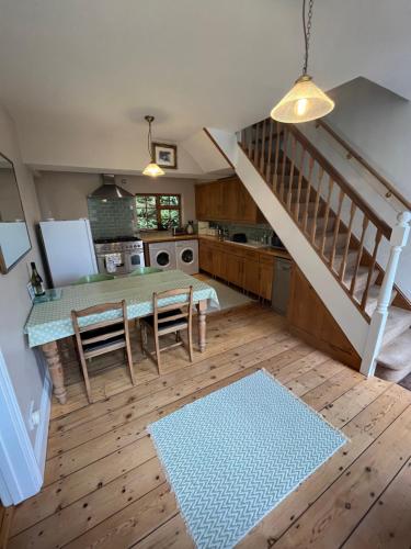 an overhead view of a kitchen with a table and stairs at Torside Holiday Cottage in Castleton