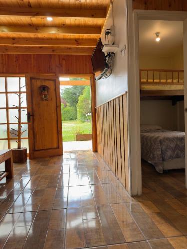 a room with a bedroom and a bunk bed at CABAÑAS Mony in Pucón