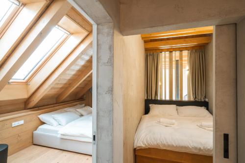 a bedroom with two beds and two windows at Aparthouse Lubno in Frýdlant nad Ostravicí