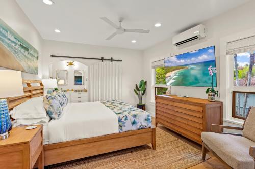 a bedroom with a bed and a tv at Poipu Kai 5 Bed 3 Bath Home- Alekona Kauai in Koloa