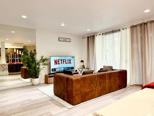 a living room with a television and a couch at Amazing Large 2 Bedroom West Hollywood Apartment in Los Angeles