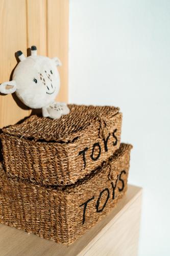 a basket with a toy cat sitting on top of it at Aparthouse Lubno in Frýdlant nad Ostravicí