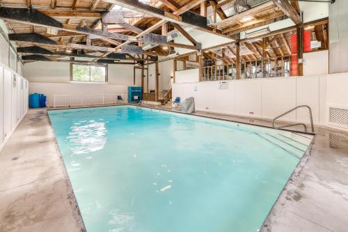 a large indoor swimming pool with blue water at Mountainside Resort III in Stowe