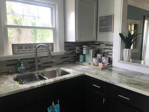 a kitchen counter with a sink and a window at Euclid Beach within reach in Euclid