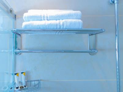 a towel rack with towels on it in a bathroom at ملك فيلا in Al Madinah