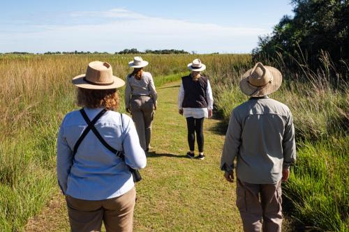 a group of people walking down a trail at El Tránsito Hotel Boutique in Concepción