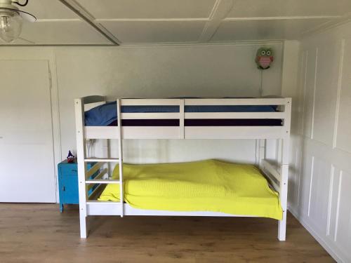 a bunk bed in a room with a yellow mattress at LaTerestone in Les Bayards