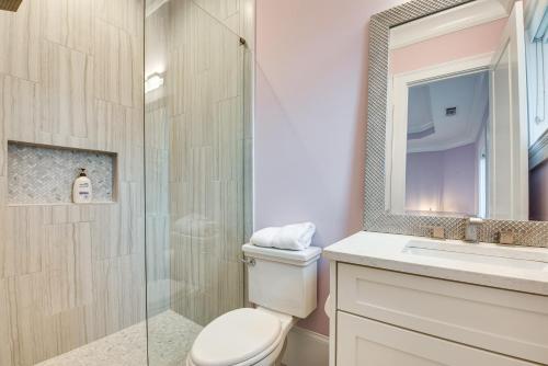 a bathroom with a toilet and a glass shower at Sprawling Suwanee Home Theater, Pool, Hot Tub! in Suwanee
